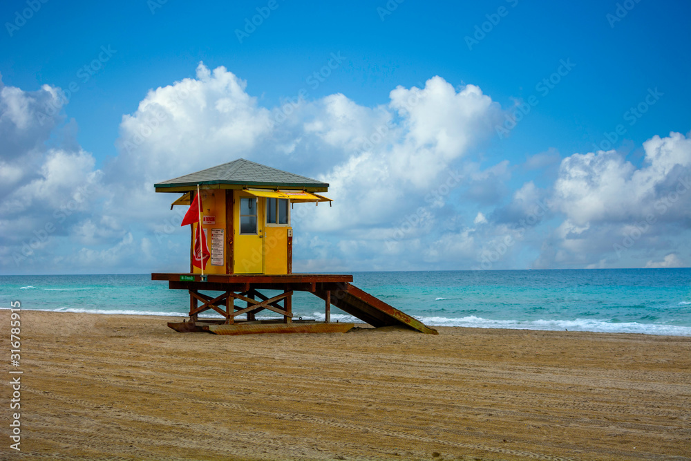 Miami South Beach dawns with lifeguard tower and coast with colorful clouds and blue sky. Miami South Beach dawns with lifeguard tower and coast with colorful clouds and blue sky.