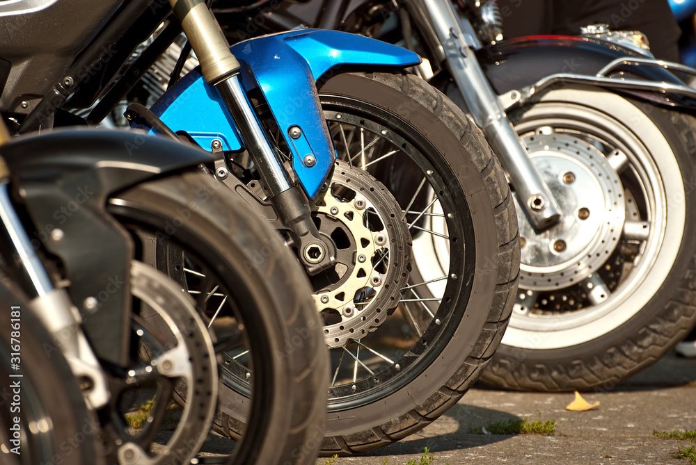 Motorcycle wheel closeup. Motorcycle metal parts. Biker meeting in the city.