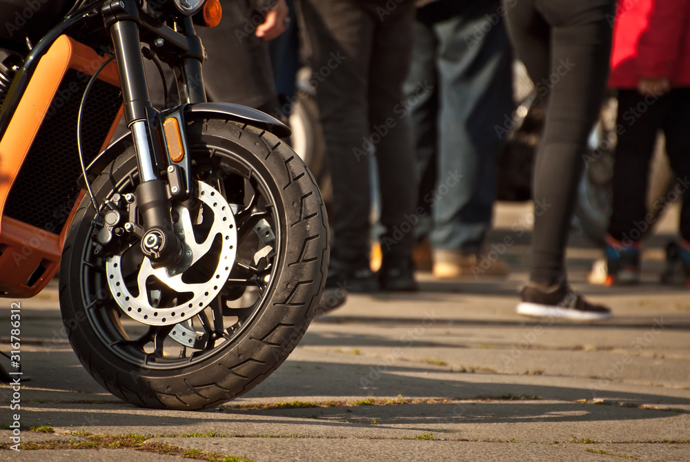 Motorcycle wheel closeup. Motorcycle metal parts. Biker meeting in the city.