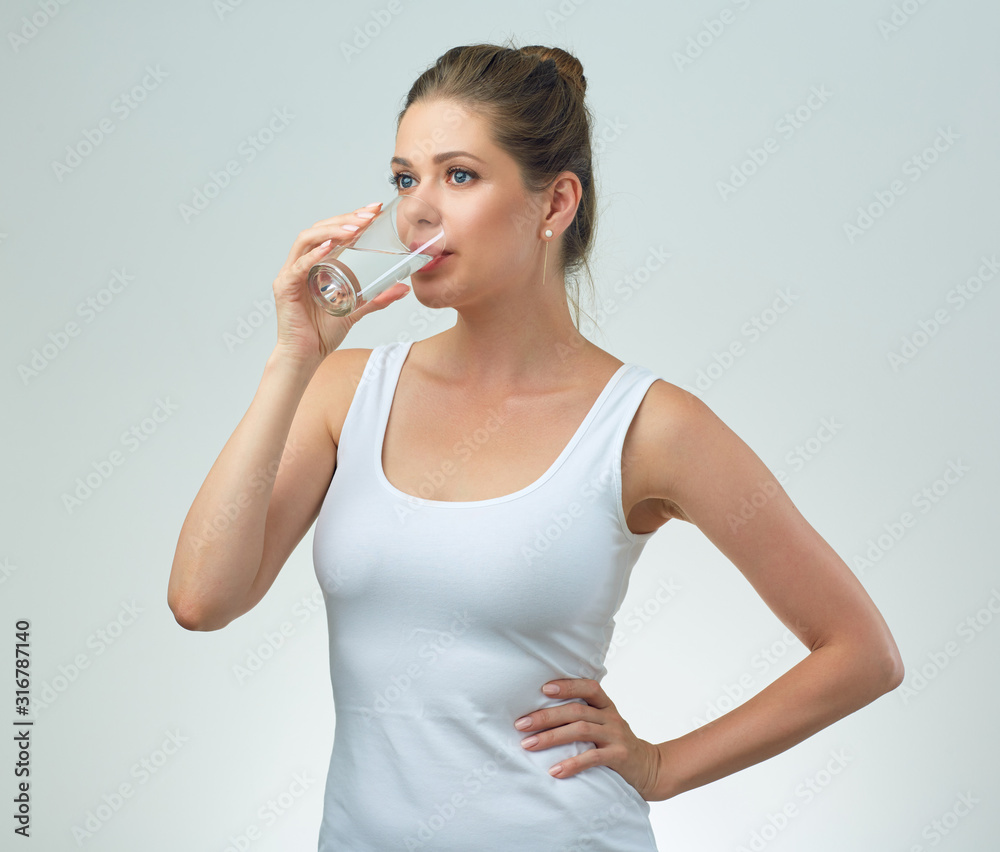 Sporty woman drinking water from glass. Sporty woman drinking water from glass.