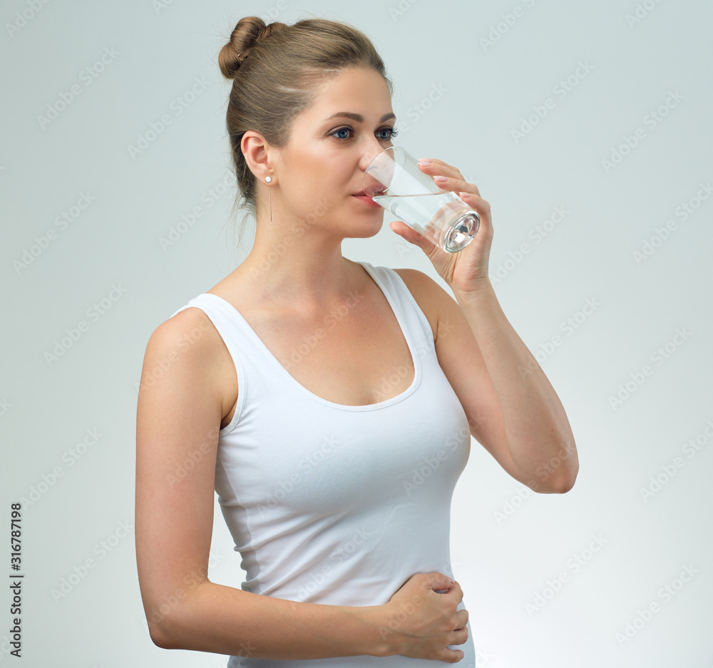 Sporty woman in white singlet drinking water. Sporty woman in white singlet drinking water.