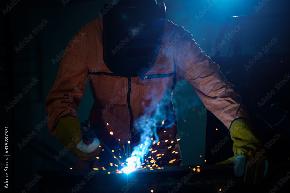 Industrial Worker at the factory welding closeup Industrial Worker at the factory welding closeup