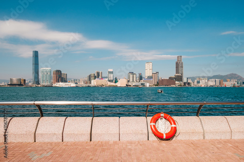 Photography Sidewalk, railing and lifebelt at Victoria Harbor waterfront promenade  with Kow