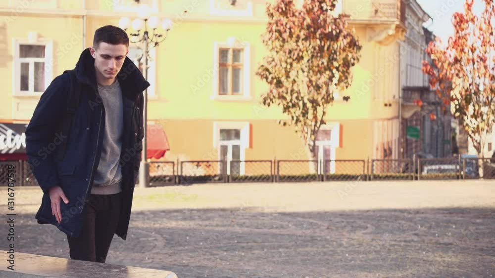Handsome guy lost something in foreign city. Confused facial expression. Tourist is seeking in his backpack. He is lost. Copy space. Action. Animation. 4K. Handsome guy lost something in foreign city. Confused facial expression. Tourist is seeking in his backpack. He is lost. Copy space. Action. Animation. 4K.