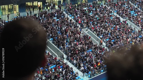 large crowd of people at the stadium, football fans. football stands, lots of people