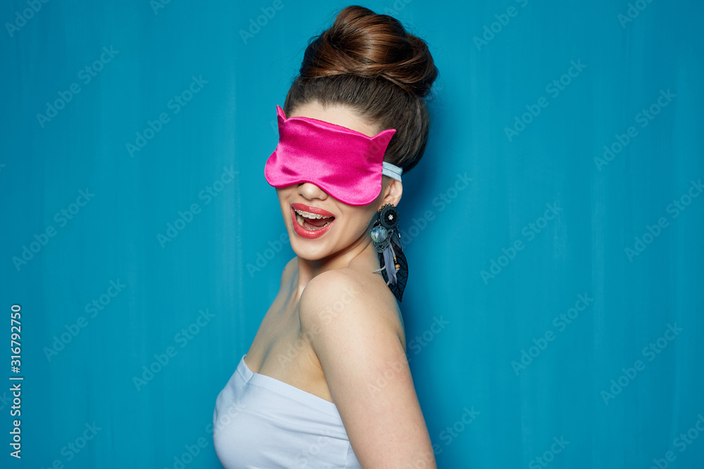 Smiling girl with dental braces wearing pink eye mask. Smiling girl with dental braces wearing pink eye mask.