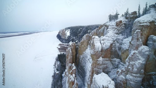 Snow-covered rocks and woods in Siberia