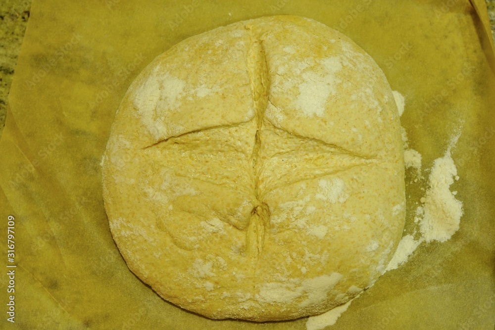 Slashing the top of a ball of proofed yeast dough for miracle overnight no knead bread