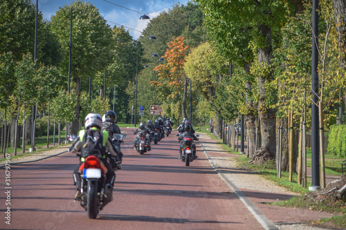 Motorcyclists riding down an alley