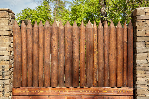 A wooden fence made of pointed logs