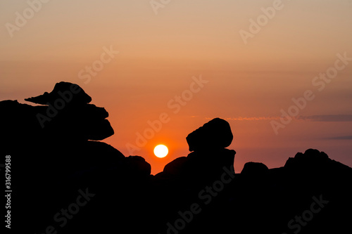 Strange rock formations silhouetted against sunrise along the C  te de granit rose   Pink Granite Coast  C  tes d Armor  Brittany  France