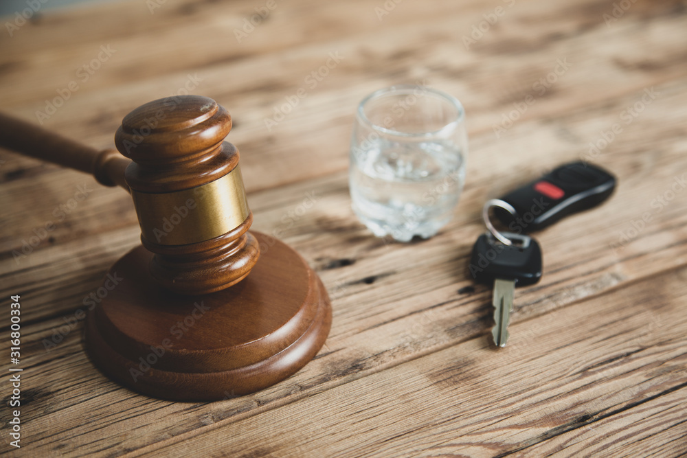 key with glass and judge gavel on desk key with glass and judge gavel on desk