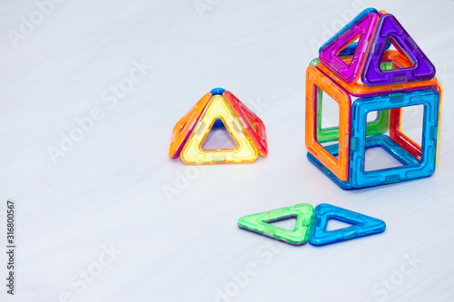 Children's colourful magnetic designer. Education background, brain kids games, empty space.