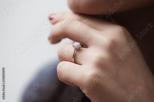 Close up of an elegant engagement diamond ring on woman finger