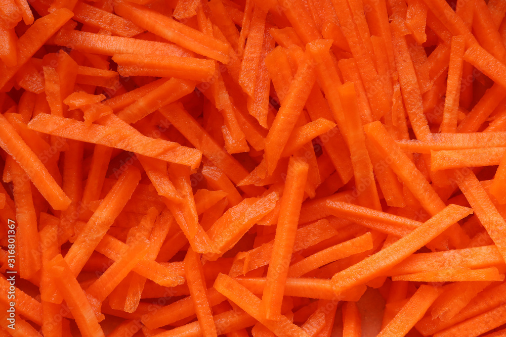 Photography of grated raw carrots pattern for food background Photography of grated raw carrots pattern for food background