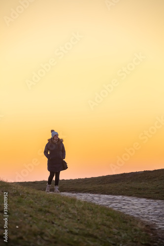 Wallpaper Mural Lady walks in the public park during a beautiful colorful afternoon winter dusk. Torontodigital.ca