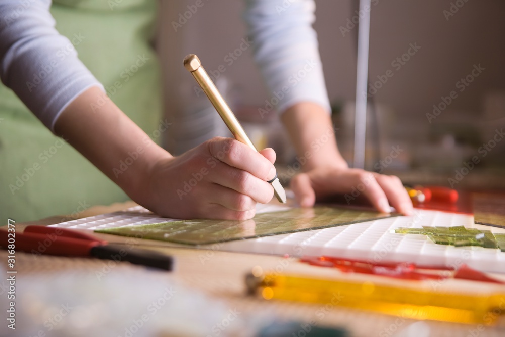 Craftswoman marking glass