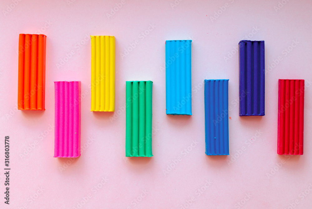 cute flower made of multi-colored plasticine clay on a pink background, multi-colored dough, minimal, children's crafts cute flower made of multi-colored plasticine clay on a pink background, multi-colored dough, minimal, children's crafts
