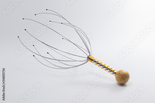 Wire head massage device for reducing tension in the body. photo