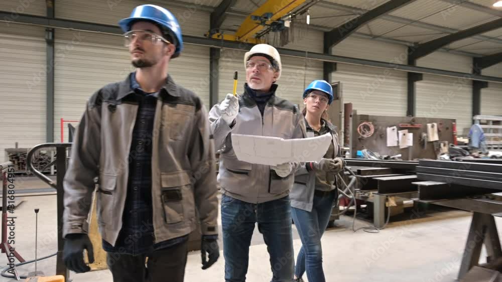 Steelwork instructor with young apprentice in workshop Steelwork instructor with young apprentice in workshop