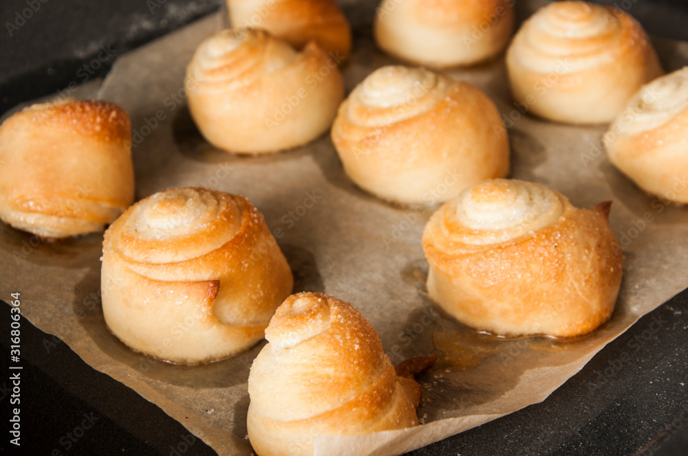 Homemade buns from the oven on a baking sheet Homemade buns from the oven on a baking sheet