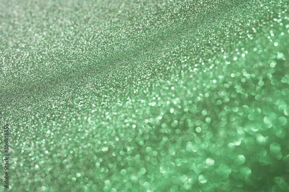 Green sparkling abstract background festive concept Blur background