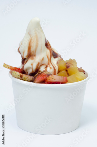  glass of ice cream, with chopped fruits and sauces photo