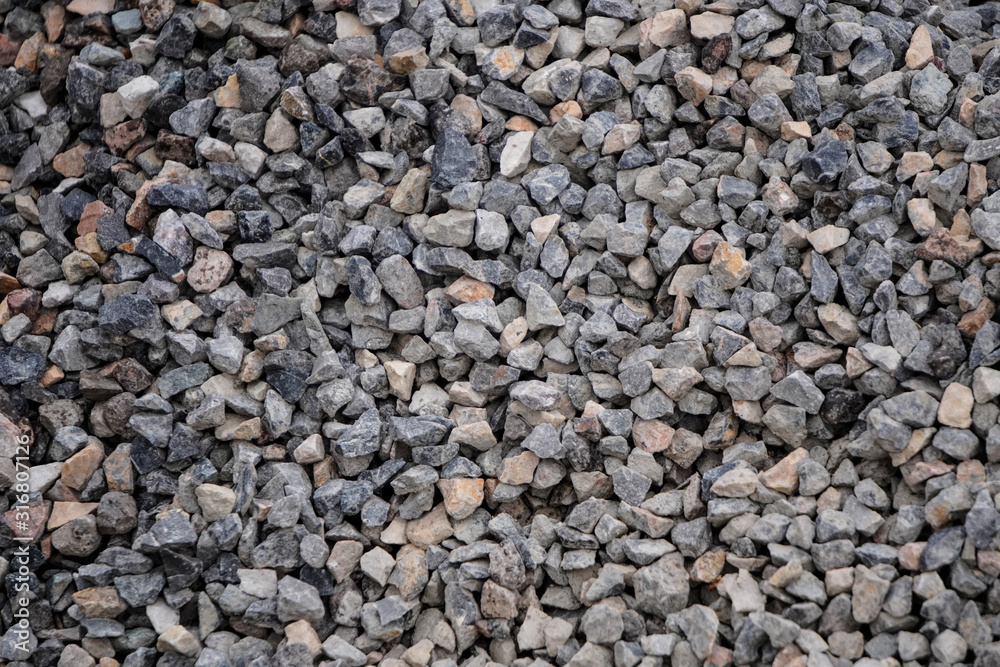 Small gray rubble or gravel, road surface. Background from a pile of small stones. Small gray rubble or gravel, road surface. Background from a pile of small stones.