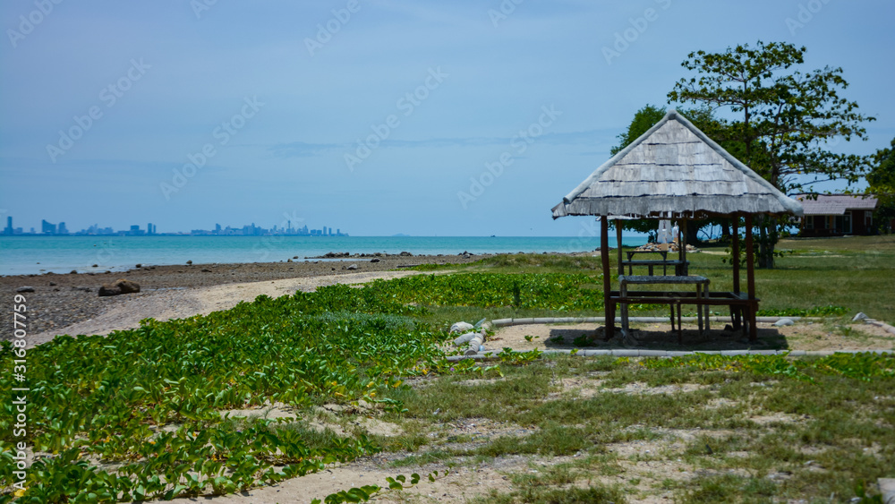 Fototapeta premium wooden cottage beside the sea,Wooden pavilion by the sea with blue sky. Gazebo for resting.