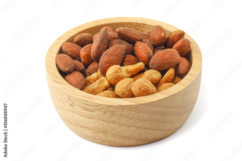 Close up salted almonds and salted cashew nuts in wooden bowl isolated on white background with clipping path. Close up salted almonds and salted cashew nuts in wooden bowl isolated on white background with clipping path.