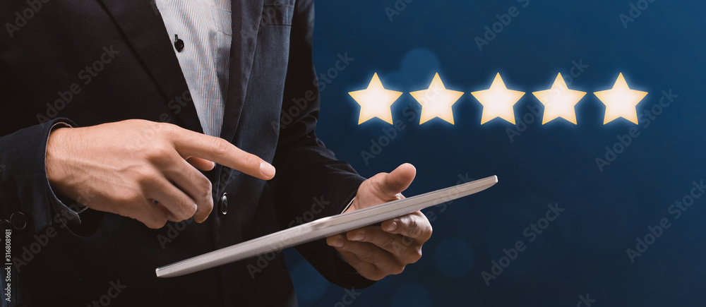 Unrecognizable businessman holding digital tablet, rating business application with 5 stars