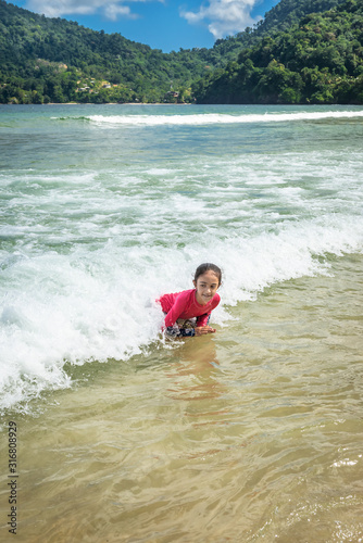 Little cute girl swimming in Maracas Bay Beach Trinidad © Altin Osmanaj