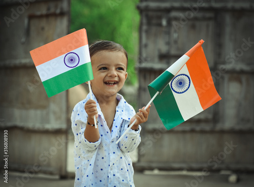 beautiful view of Indian kid with Indian flag in his hand photo