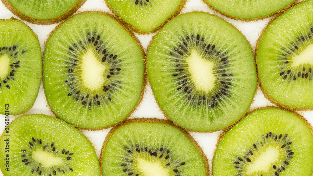 Abstract photo of a green slices kiwi fruit background. Food concept. flat lay, top view. Close up. Banner. Abstract photo of a green slices kiwi fruit background. Food concept. flat lay, top view. Close up. Banner.
