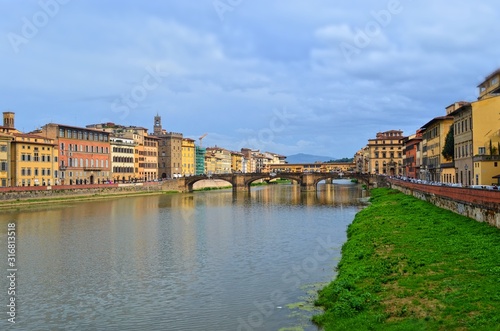 cityscape overlooking the bridge and the flowing Arno river in Florence
