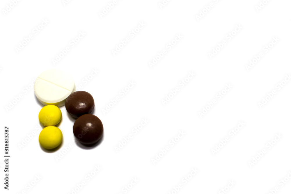 Multi-colored pills on a white background, place for text. Multi-colored pills on a white background, place for text.