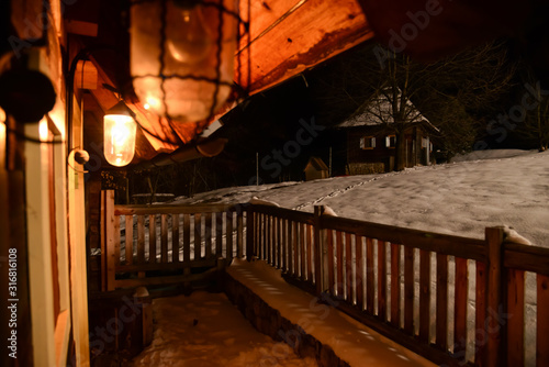 Romanesque night from the yard to the adjoining house covered in snow