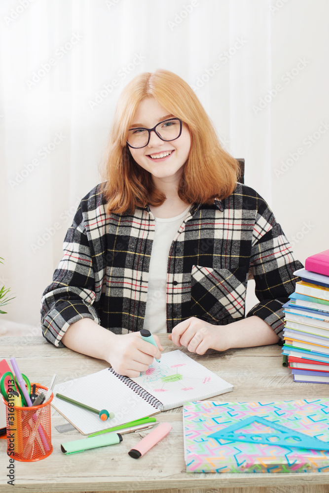 smiling teenager student girl doing homework at home, education and school concept smiling teenager student girl doing homework at home, education and school concept