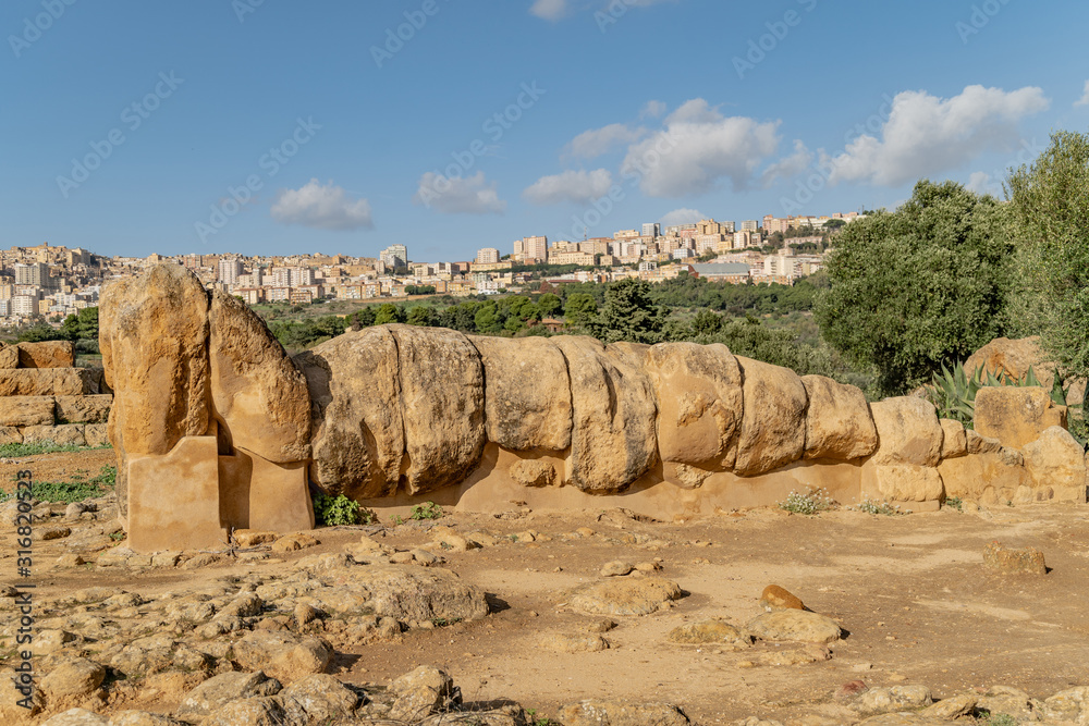 Giant Telamon, Atlas supporting statue of ruined Temple of Zeus in the Valley of Temples of Agrigento, Sicily, Italy.