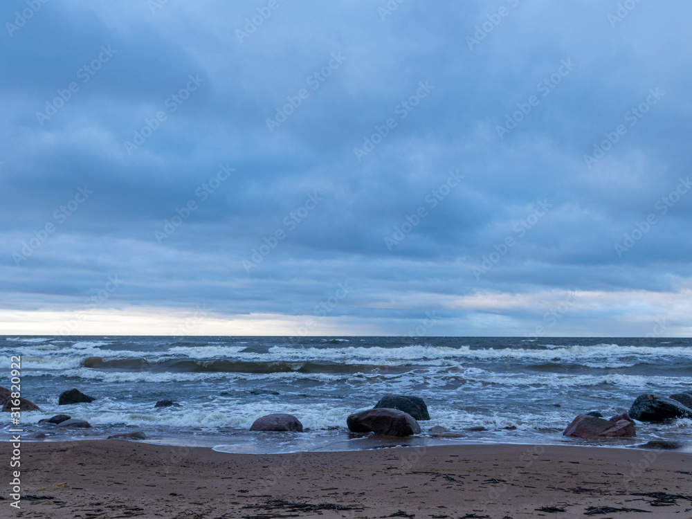 beautiful seascape, dark clouds and white waves