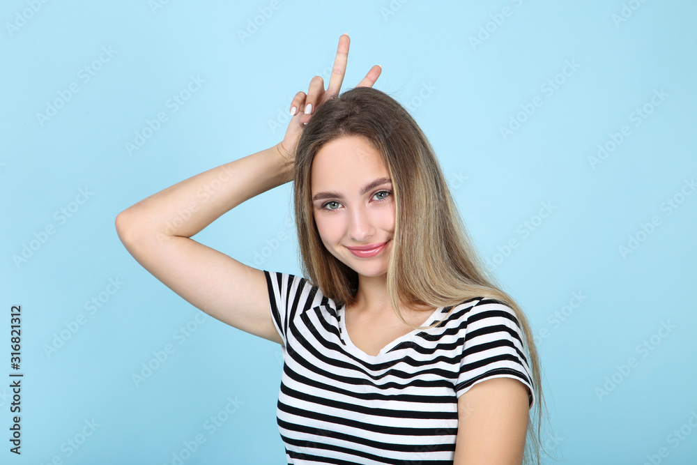 Beautiful young woman on blue background