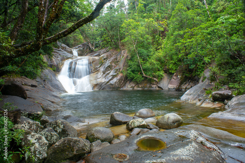 Fotografia Josephine Falls and Fast Flowing Stream in rainforest at Wooroonooran National Park near Cairns, Queensland Australia