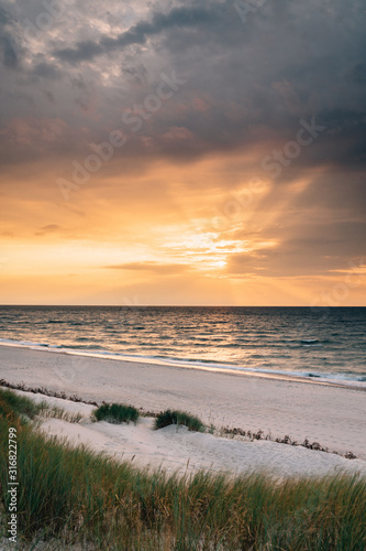 Late summer sunset on the Baltic sea coastline. Landscape of a beach near Ustka  Poland.