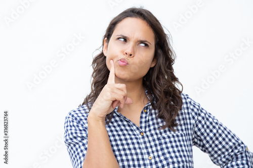 Photography Thoughtful young woman with finger on cheek