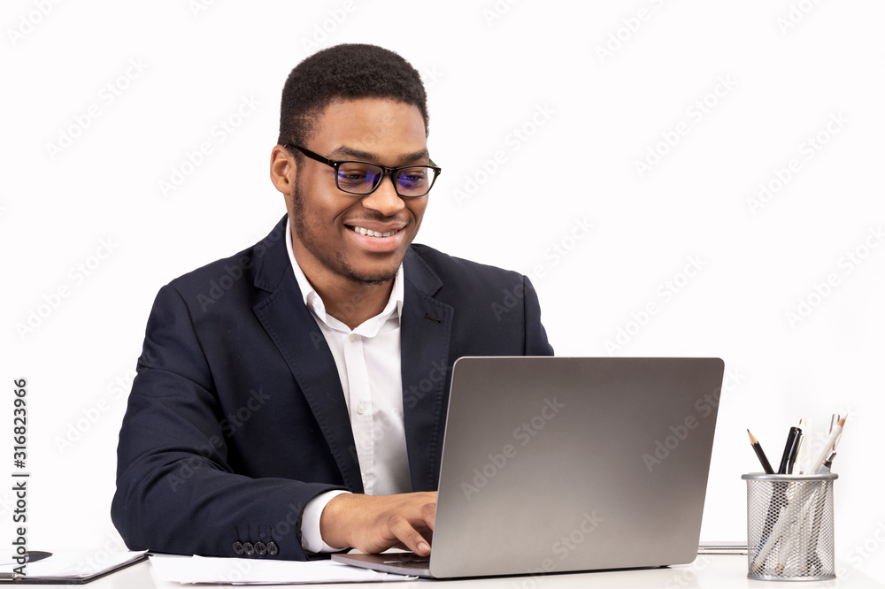 Concentrated african american man working with laptop