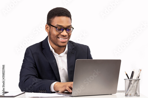 Concentrated african american man working with laptop