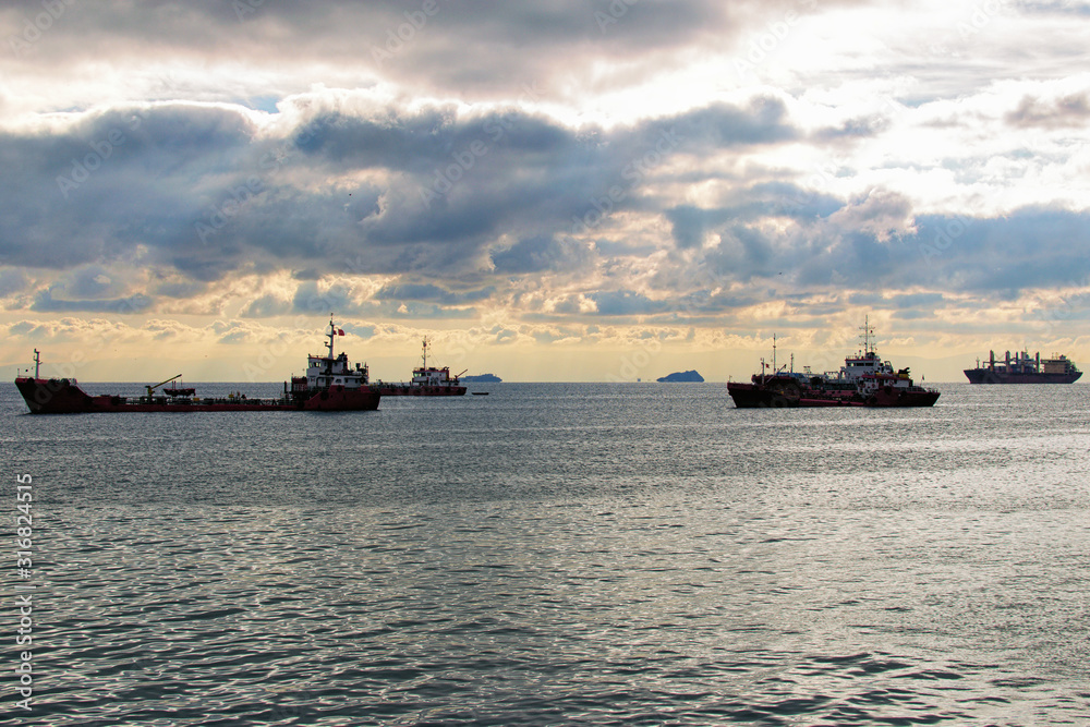 Merchant ships standing on the roadstead. Import, export and business logistic. International water transport. Picturesque view of Marmara Sea against thunderclouds. Istanbul, Turkey