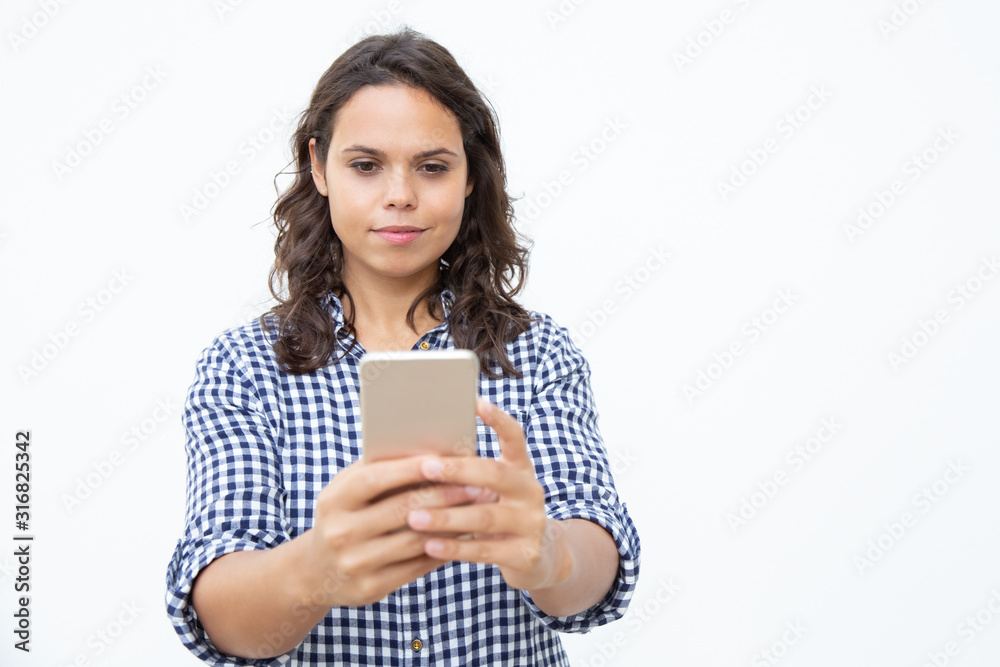 Smiling woman using mobile phone. Front view of beautiful happy young woman using smartphone on white background. Technology concept Smiling woman using mobile phone. Front view of beautiful happy young woman using smartphone on white background. Technology concept