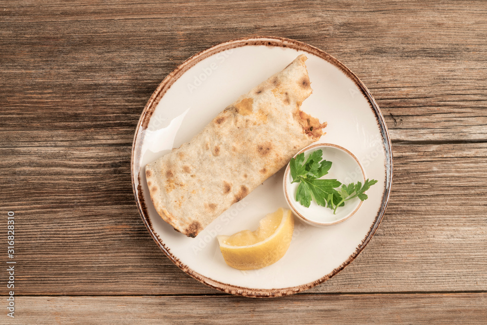 biten turkish pizza on wooden table biten turkish pizza on wooden table