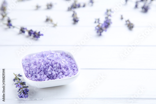 Lavender flowers and spa salt on white wooden table